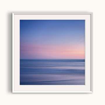 Blue and pink seascape photograph at sunset